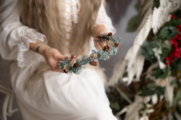 Winter flower half wreath with pine cones