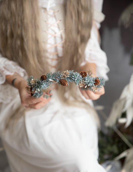 Winter flower half wreath with pine cones