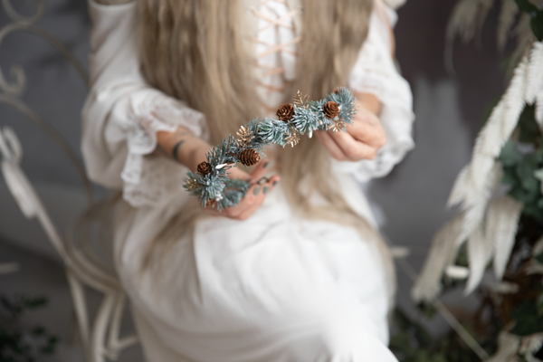 Winter flower half wreath with pine cones