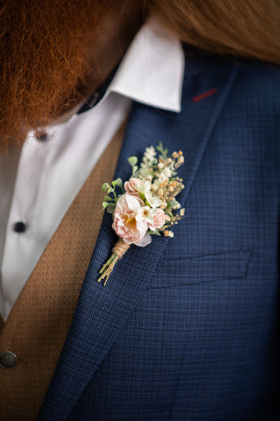 Blush flower boutonniere for groom