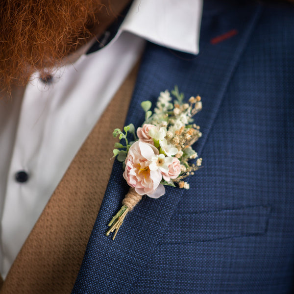 Blush flower boutonniere for groom